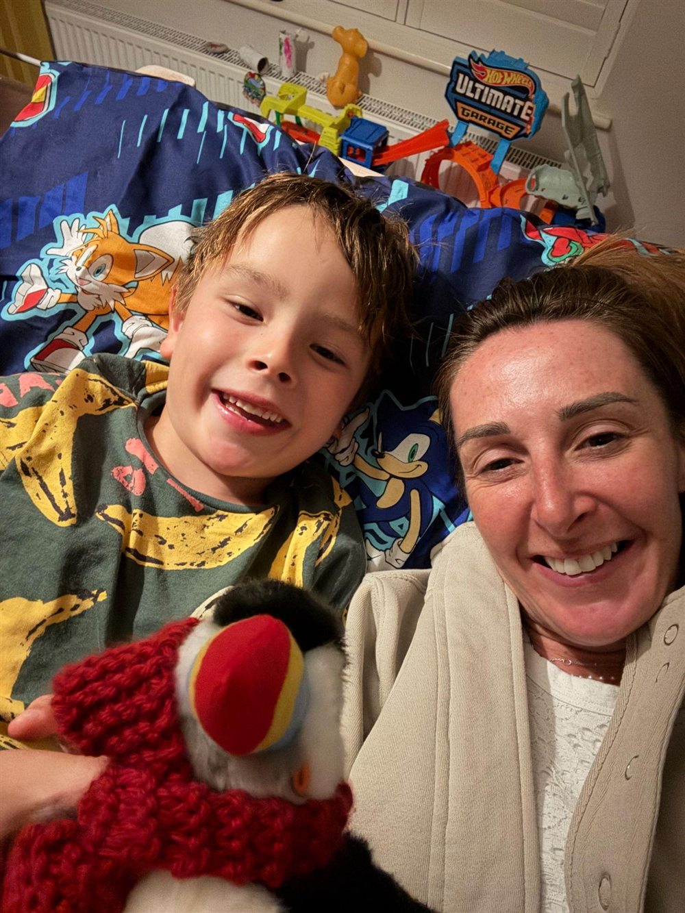 Jools and Hugo smiling with their handmade Finn puffin